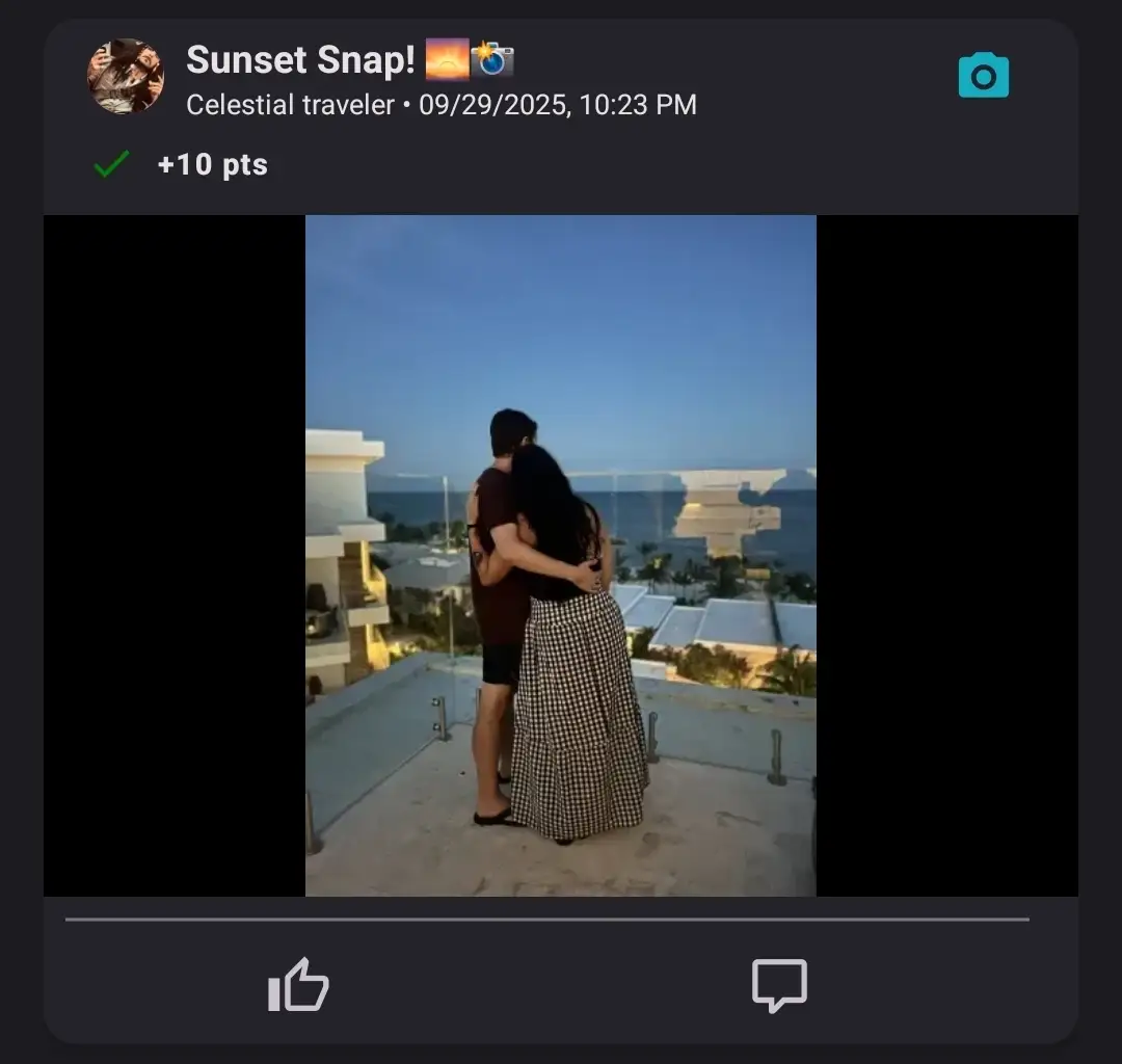 A couple standing on a balcony overlooking a coastal sunset, with their arms around each other