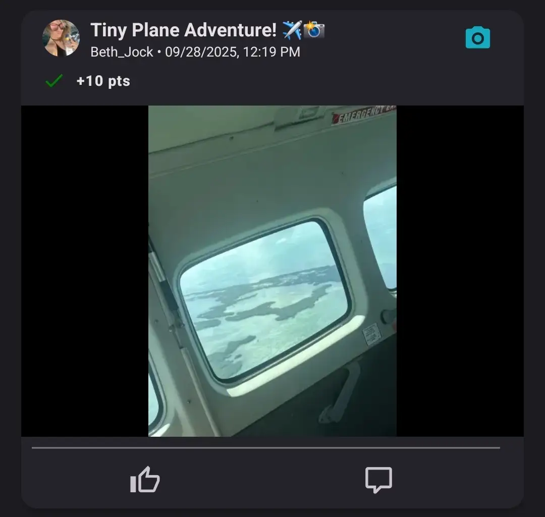 A view of islands and water through the window of a small airplane in flight