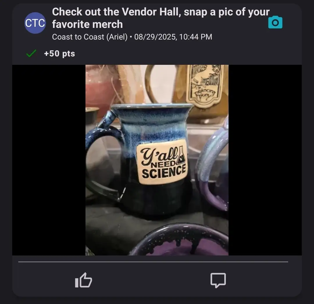 A ceramic mug on display with the words 'Y'all Need Science' at a vendor hall