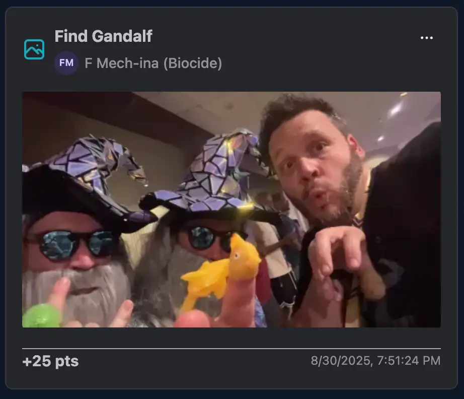Players posing with 2 cosplayers dressed as Gandalf