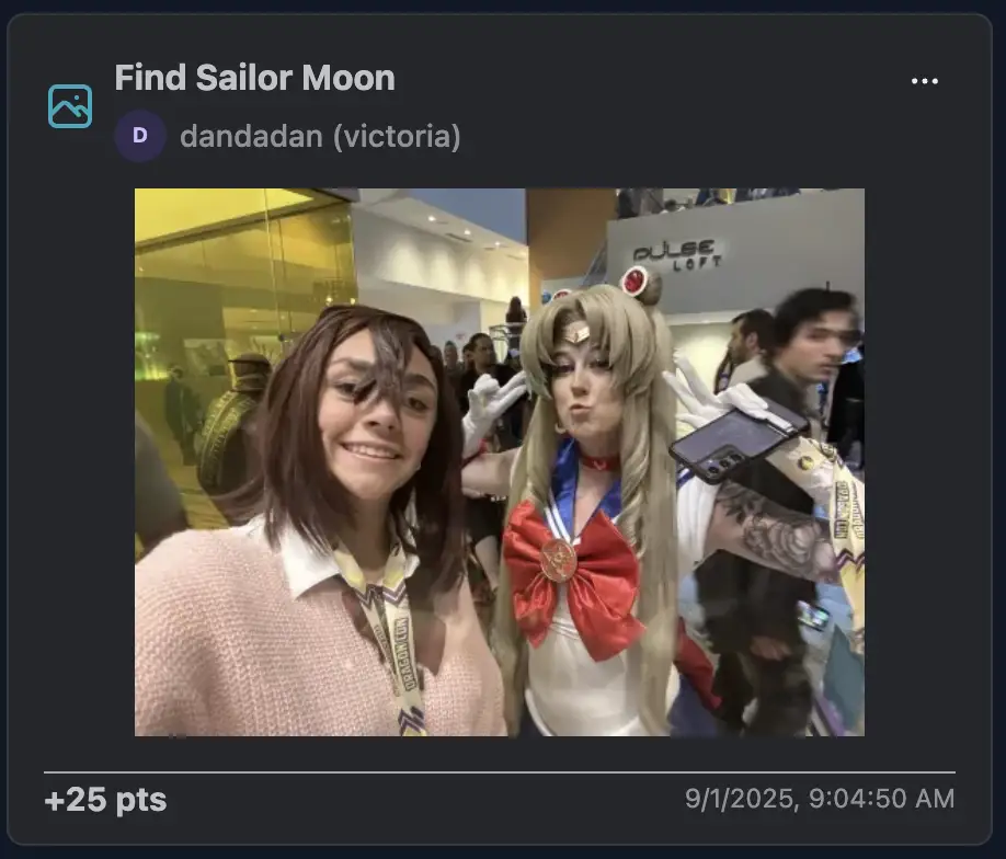 A cosplayer dressed as Sailor Moon striking a peace pose, alongside another cosplayer smiling proudly for the selfie.