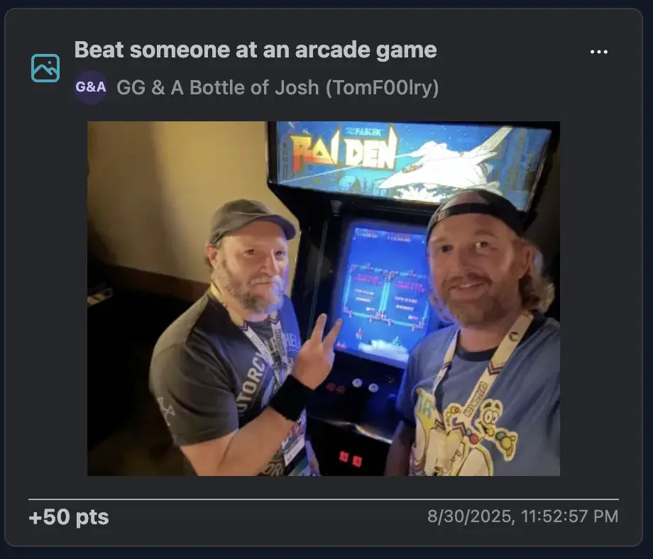 Two players posing victoriously in front of a glowing arcade cabinet, one flashing the peace sign like they've just conquered the galaxy.