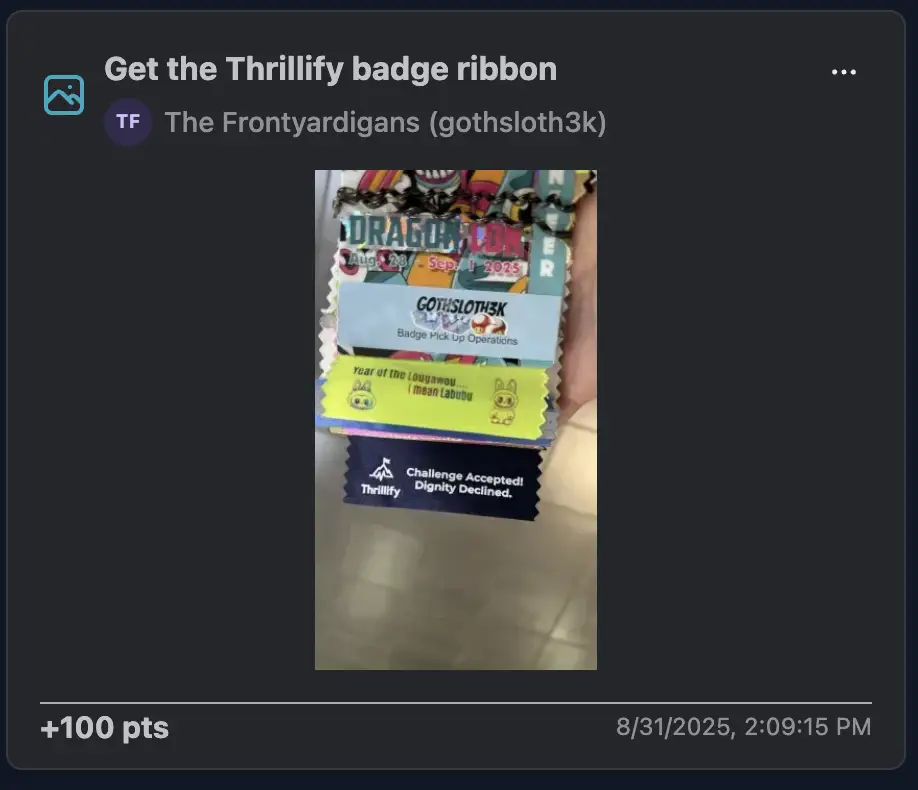 A Dragon Con badge with multiple colorful ribbons attached, proudly showing off the Thrillify ribbon at the bottom.