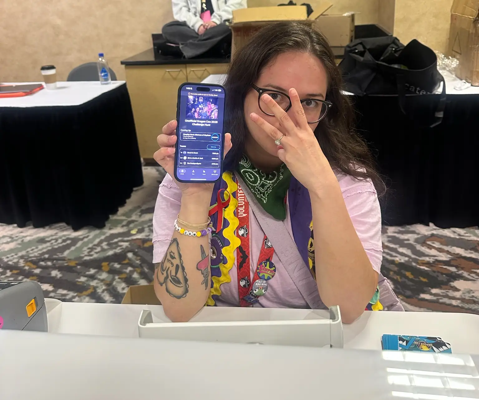 A member of The Frontyardigans team proudly displaying the Thrillify app on their phone.